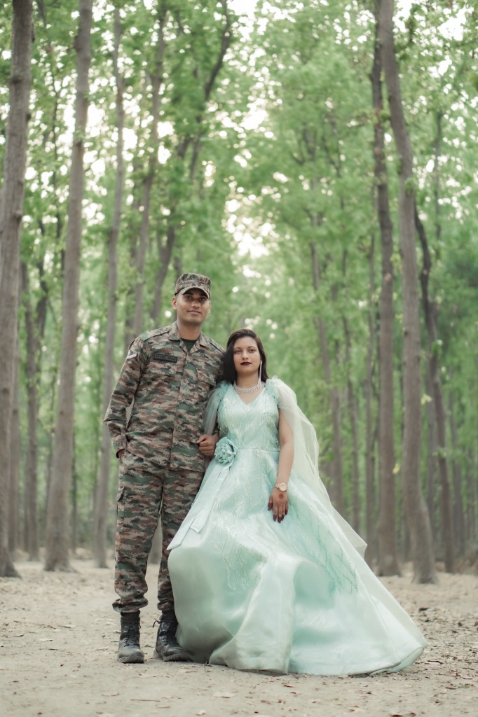 Groom Faiz in military officer uniform standing with Bride Yasmin in grand mint ball gown in forest