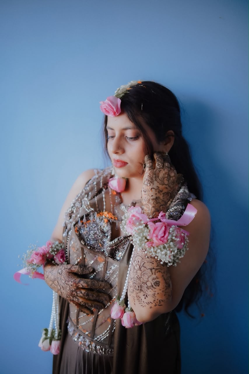 Bride Sambhavi adorned with handcrafted fresh floral haathphool jewelry and intricate henna