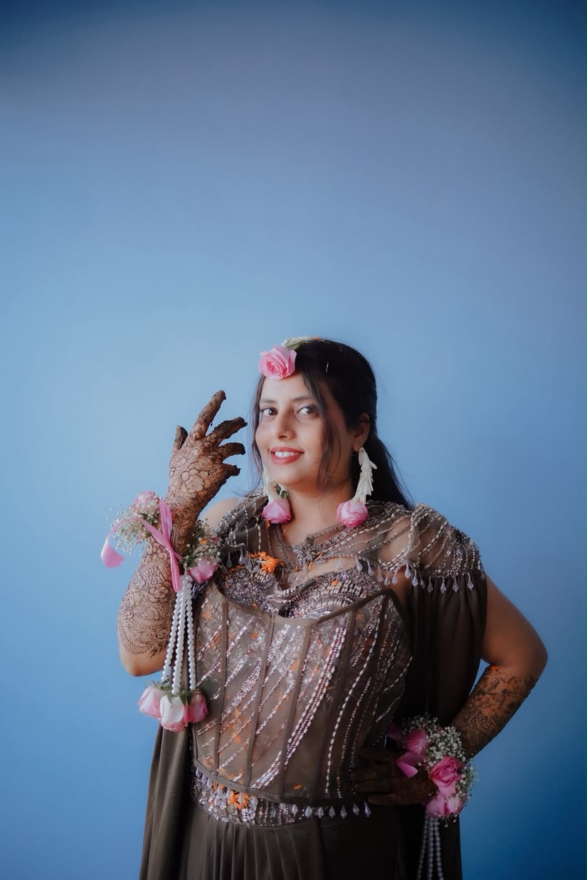 Bride Sambhavi smiling radiantly and displaying intricate bridal mehendi artwork